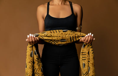 Karyn Poe, Owner of Jayei Athleticss, holding mud cloth